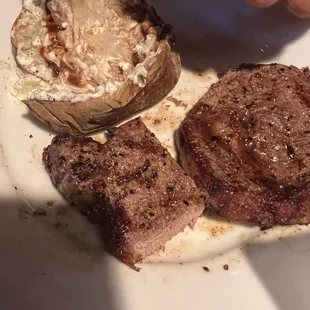 Ribeye med well cooked, baked potato with butter and sour cream and steak sauce.... The ribeye seasoned so well that no sauce was needed