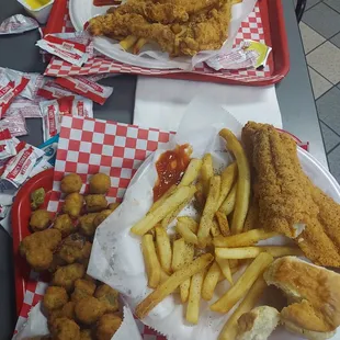a tray of fried chicken, fries, and ketchup