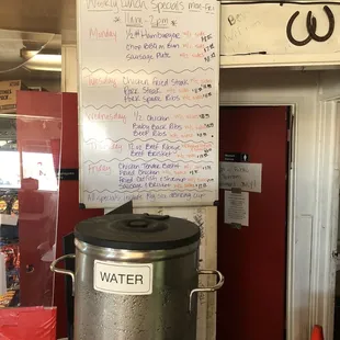 ows a metal barrel with a sign on it