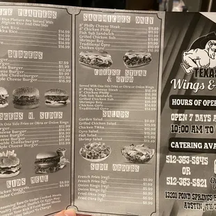 a hand holding a menu