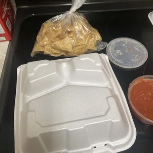 Upside down food container our tacos were in and the little bag of chips we paid for.