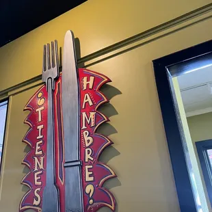 a knife and fork on the wall