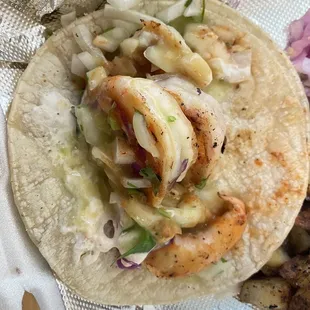 a taco with shrimp and vegetables