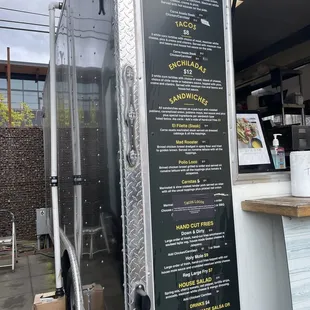 a food truck with a menu on the side