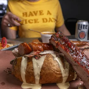 a plate of ribs and a baked potato