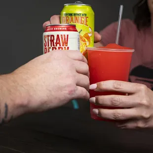 a man holding a drink and a woman holding a drink