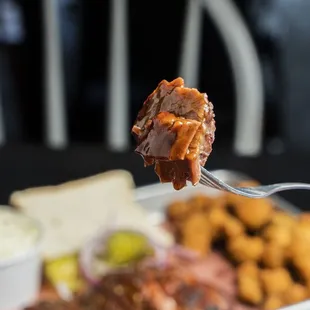 a fork holding up a piece of meat