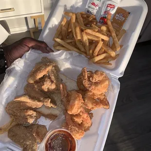 a tray of fried chicken and french fries