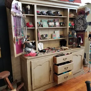 a wooden cabinet with drawers and a clock