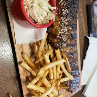 a plate of ribs, fries and coleslaw