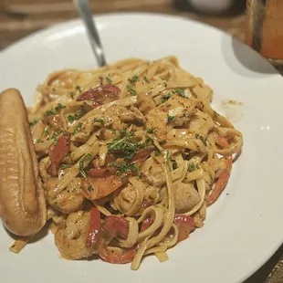 a plate of pasta and a hot dog