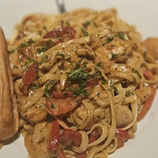 a plate of pasta with chicken and vegetables