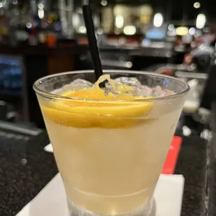 a glass of lemonade with a straw