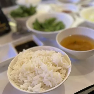 a bowl of rice and bowls of soup
