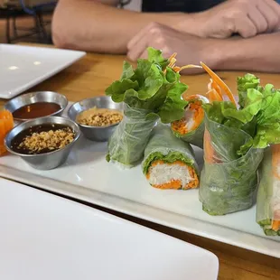 Fresh spring roll appetizer. It is served with three sauces that are each even better than the last.