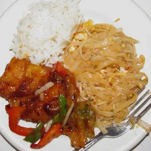 Steamed rice, pad Thai, and Bangkok vegetables on plate. They are served in much larger dishes.