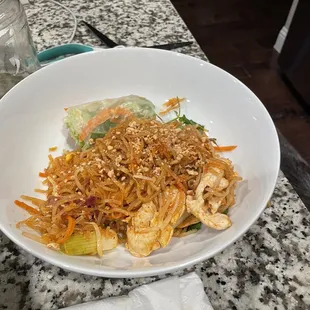 Chicken pad Thai and half a spring roll.