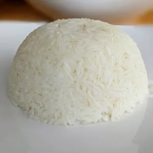 A dome of rice on a white plate. Legend has it that monks learn the craft of rice placement-- wait, it&apos;s formed with a bowl? Okay then.