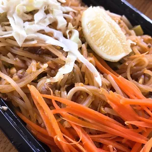 a plate of noodles and carrots