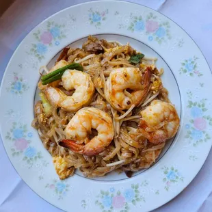 a plate of shrimp and noodles