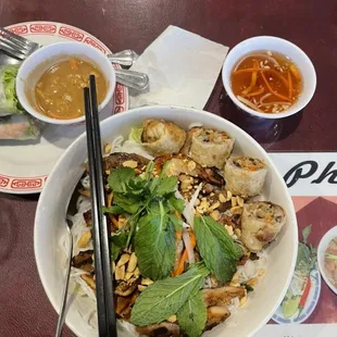 this combo bowl (shrimp, pork, and chicken with imperial rolls) is life a la mickey mouse layout. spring rolls in the top left corner