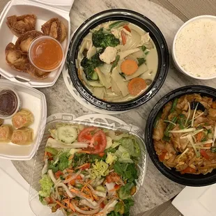 Clockwise: Green Curry with white rice, Drunken Noodles, Calamari Salad, Tulip Dumplings, Phu-ket Dumplings