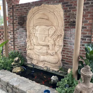 a stone carving of a buddha