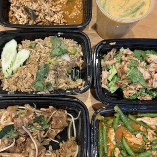 four takeout containers of food