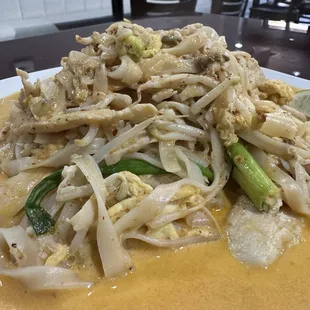 Pad Thai Curry: A rich blend of coconut milk, bold spices, and tender noodles topped with fresh herbs.