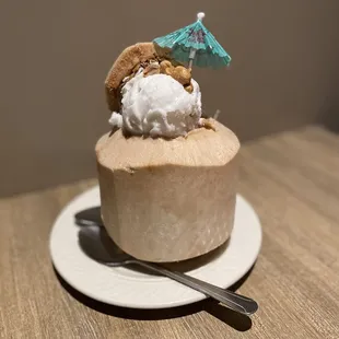a dessert on a plate with a blue umbrella