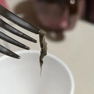 a fork stuck in a cup