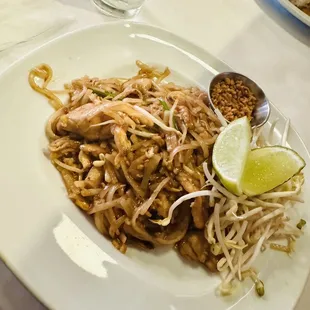 a plate of noodles with meat and vegetables