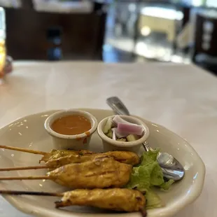 skewered chicken skewers with dipping sauce