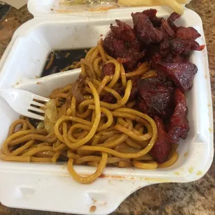 noodles and meat in a styrofoam container