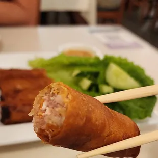 a person holding a pair of chopsticks