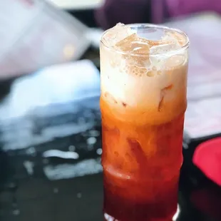 a glass of iced tea on a table