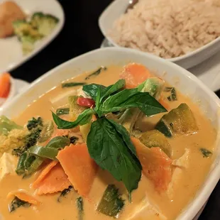 a bowl of soup with rice and vegetables