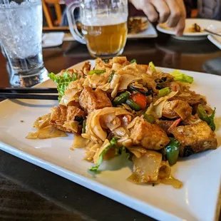 a plate of food with chopsticks