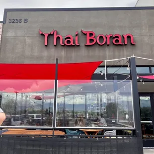 a woman sitting outside a restaurant