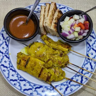 Chicken skewers marinated in coconut milk and spices then grilled and served with a peanut sauce and cucumber relish