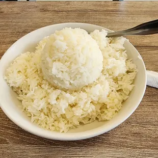 a bowl of rice with a spoon