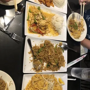 a variety of dishes of food with chopsticks