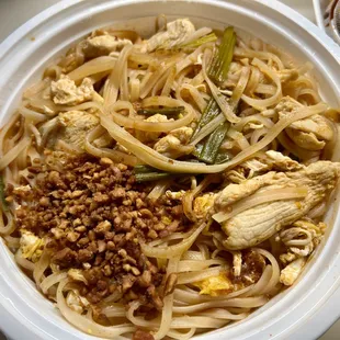 Chicken Pad Thai with stir fried thin rice noodles with egg, scallions, bean sprouts in homemade tamarind sauce. (Ground peanut on the side)