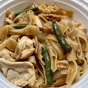 Chicken Thai Basil Noodles with stir-fried wide rice noodles, green beans, onions, bell peppers and basil leaves in homemade chili sauce