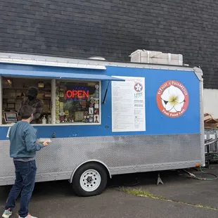 a man standing in front of a food truck