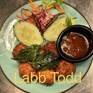 a plate of food with a bowl of sauce