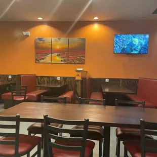a dining area with tables and chairs