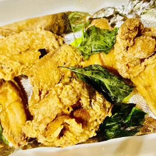 Deep Fried Wings Topped With Fried Basil.