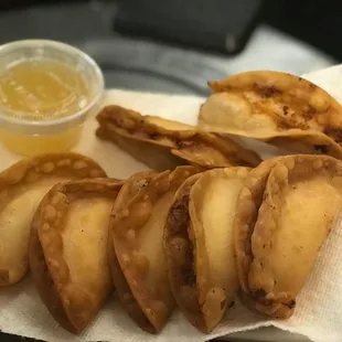 Crab Rangoon: A mixture of imitation crab-meat and cream cheese in crispy dough with pineapple sauce