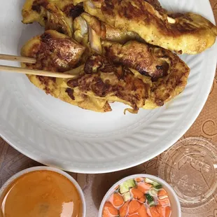 Chicken satay with peanut sauce and carrot cucumber dipping sauce